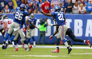 In the game of East Rutherford, NJ, USA, on September 21, 2014, New York Giants #26, Antrelle Rolle intercepts a pass against the Houston Texans in the second quarter of the game that took place at the Metlife Stadium. Photo by Public domain.