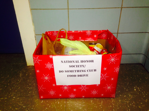 The National Honors Society puts a box by the elevator for students to put canned foods in to donate to the hungry. Students are also able to donate food whenever they want throughout the day. Only non-perishable foods will be taken! Photo by Gabriella Grimando
