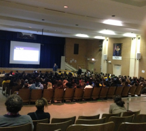 Students watch attentively as Mr.Nisonoff talks during the March town hall. Picture by abriella Grimando.
