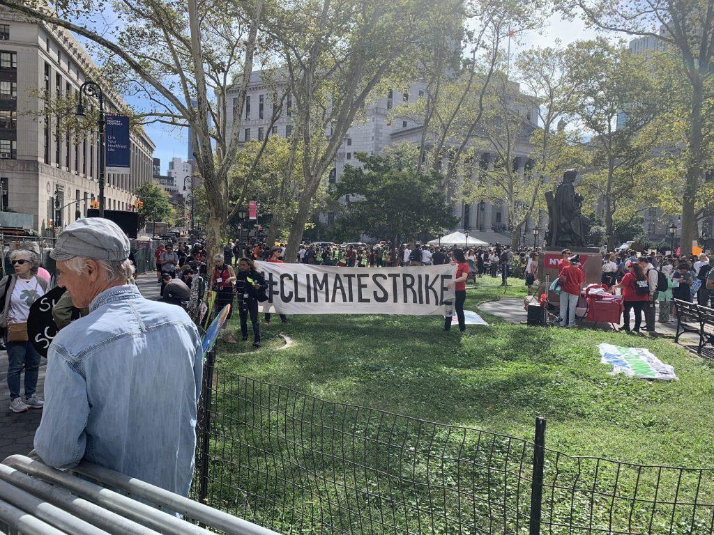 Protesters holding a banner reading #ClimateStrike in New York City