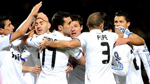 Madrids French forward Karim Benzema (2ndL) is congratuled by teammates after scoring during the Champions League football match Olympique de Lyon versus Real Madrid on February 22, 2011 at the Gerland stadium in Lyon, central eastern France.